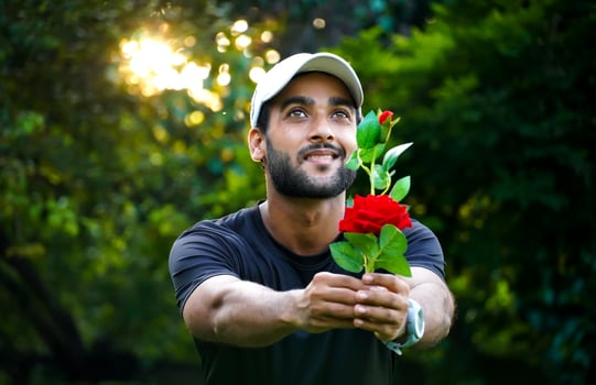 proposing to his Girlfriend man with beautiful red rose giving to girl photo