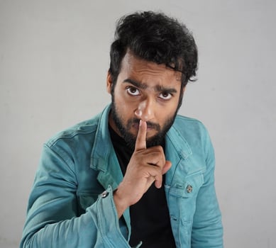 a man telling using gesture keep quite photo