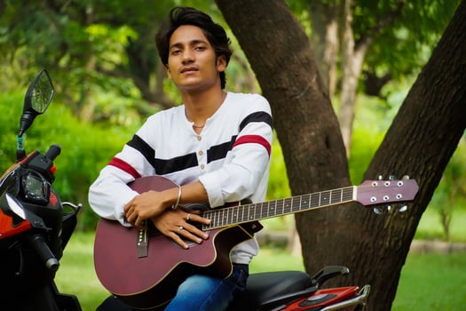 boy with red guitar with red biike photo