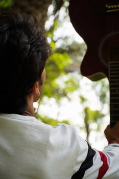 a man with guitar with USA logo t shirt photo