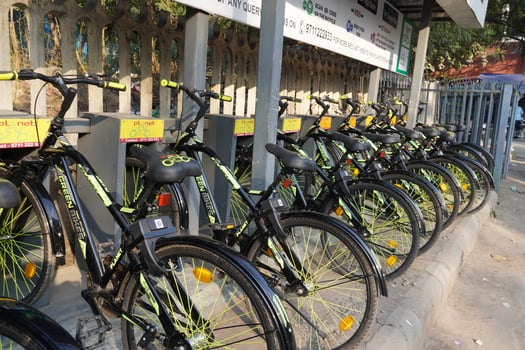 Bikes standing in a row on the city street photo