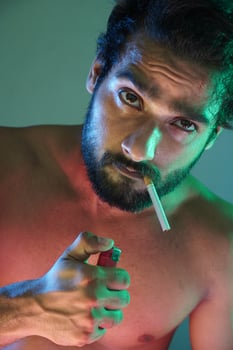 man smoking with cigarette and lighter photo