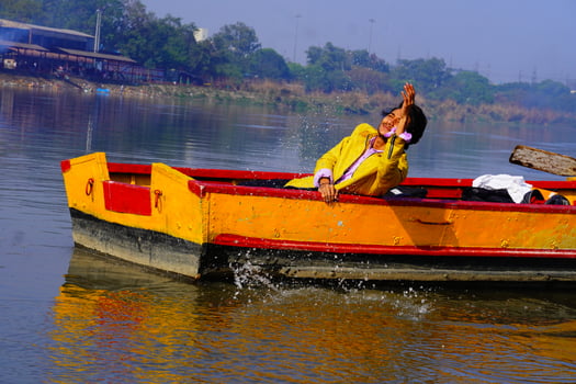 man enjoy with water sitting in the boat photo