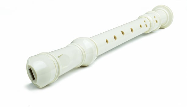 Plastic flute, universal type, off-white or pearl color. Change the tone by covering the holes with your fingers. and use your mouth to blow air out photo