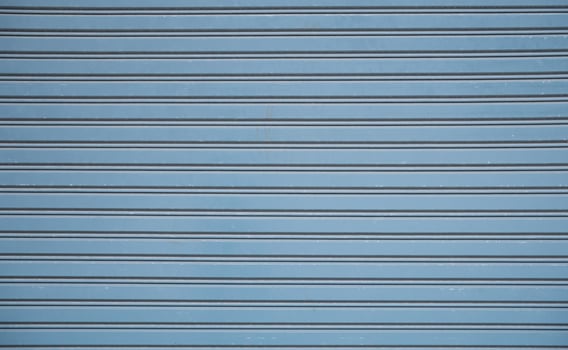 Straight lines or parallel lines of an iron door Rolling doors made of metal. Line pattern, rectangular shape from a rolling door Suitable for making banner, wallpaper or background. photo