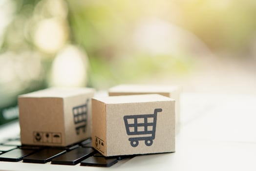 Shopping online. Cardboard box with a shopping cart logo on laptop keyboard. Shopping service on The online web. offers home delivery. copy space photo