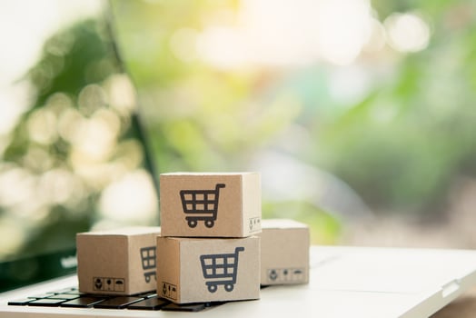 Shopping online. Cardboard box with a shopping cart logo on laptop keyboard. Shopping service on The online web. offers home delivery. copy space photo