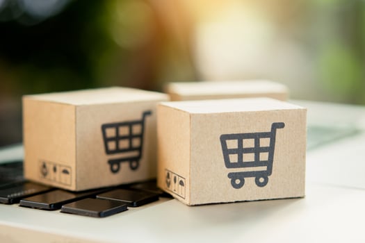 Shopping online. Cardboard box with a shopping cart logo on laptop keyboard. Shopping service on The online web. offers home delivery. copy space photo