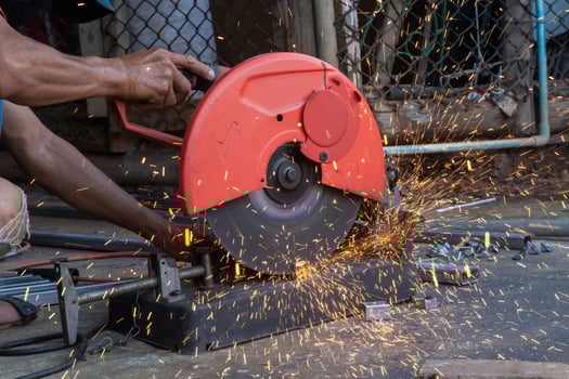 Worker cut steel with cut off wheel saw, cutting wheels. photo