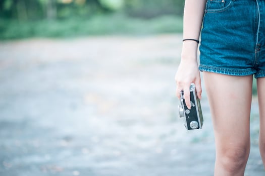 A woman holding a camera, a woman who loves photography. Close-up photography photo