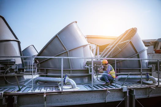 Industry engineer under checking the industry cooling tower air conditioner is water cooling tower air chiller HVAC of large industrial building to control air system. photo