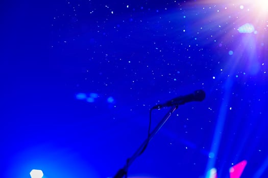 Show on stage with microphone on with bright background in celebration concept with copy space.... photo