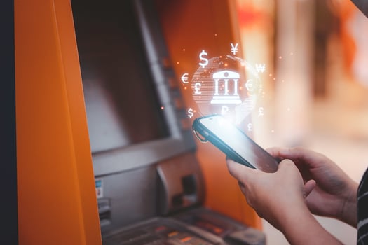 Woman hand using smartphone for transfer money between mobile phone and Automatic Teller Machine or ATM , Financial technology concept. photo