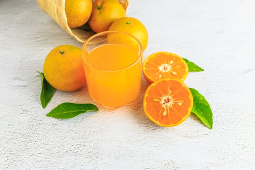 fresh orange juice with orange fruit in basket photo