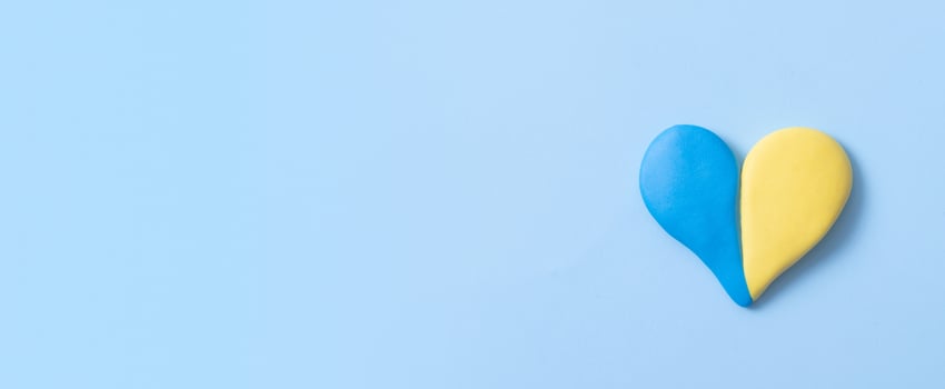 Heart shape of yellow-blue colors of the Ukrainian flag with copy space. Peace in Ukraine concept. Banner format photo