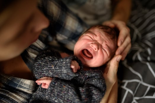 Mom holds in her arms her newborn son. photo