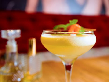pisco sour cocktail on the table in bar photo