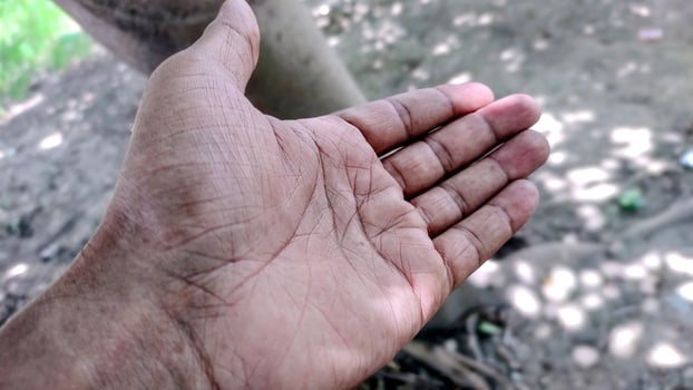 Giving a helping hand, asking or offering help close-up shot of a asian man photo