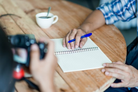 Writing on paper at work on the table in the morning, business ideas. There is space for copying. photo