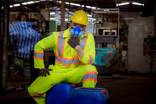 Engineer industry wearing safety uniform ,black gloves ,gas mask feel suffocate when under checking chemical tank in industry factory work. photo