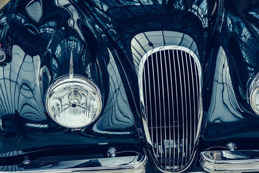 closeup of the headlights and front bumper on vintage automobile photo