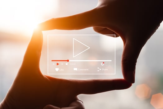Concept of watching live video online, hands making framing view on blurred sunset background. photo