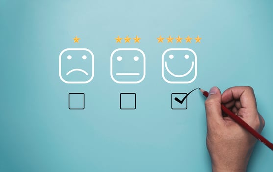 Hand tick or check mark to select smile face with five stars on blue background , Customer and client  evaluation after use product and service concept. photo