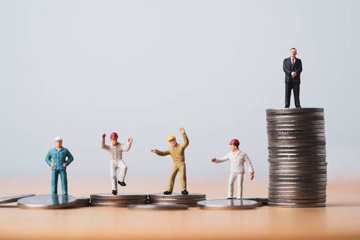 One businessman standing on highest coins stacking and many workers standing on lower coin for different income and unequal in society concept. photo