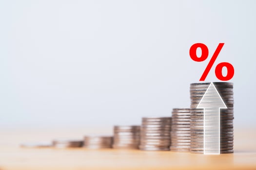 Red percentage sign on coins stacking with up arrow for interest financial increase and economic profit investment growth concept. photo