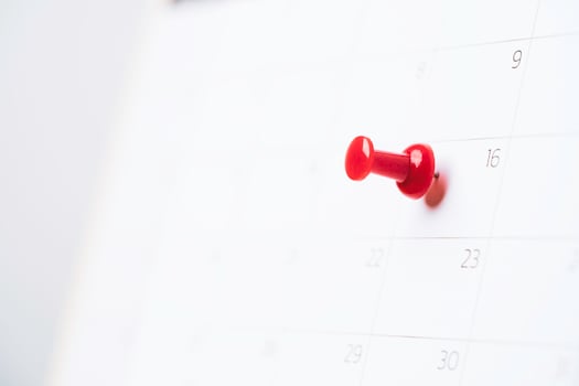 Red pin lace to white calendar with copy space for appointment plan concept. photo