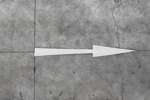 Traffic direction painted on the concrete road. Straight forward arrow. photo