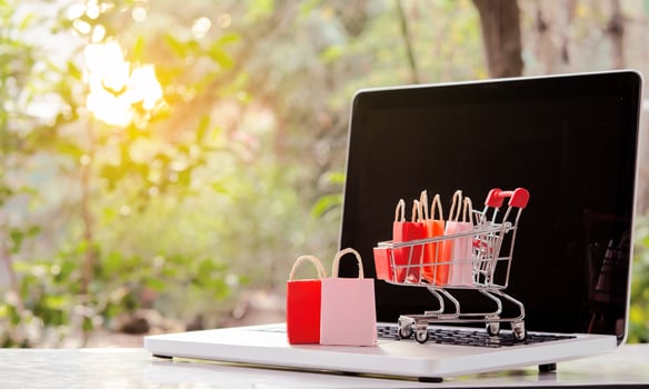 Shopping online. Shopping bags with a shopping cart logo in a trolley on laptop keyboard. Shopping service on The online web. offers home delivery photo