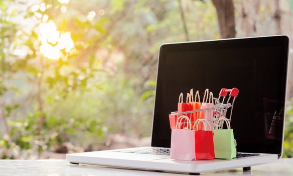 Shopping online. Shopping bags with a shopping cart logo in a trolley on laptop keyboard. Shopping service on The online web. offers home delivery photo