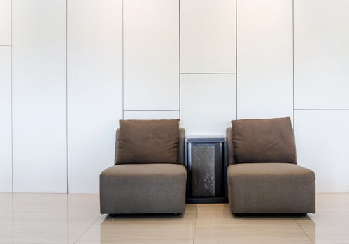 White modern interior with modern brown design sofa chair and white wall interior photo