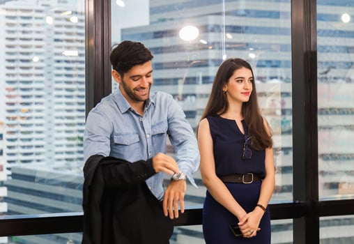 Businesswoman and businessman talking together other in modern office photo