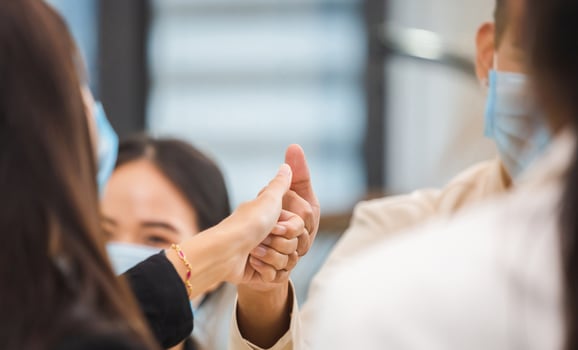 Successful of business partners making thumbs up gesture. Business team making promises with fingers. Successful teamwork concepts. photo
