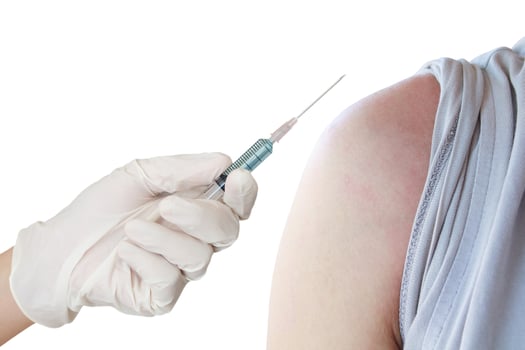 doctor makes vaccination in the shoulder of patient photo