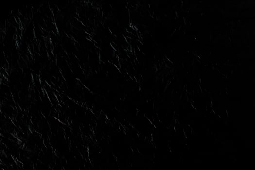 Black wrinkled plastic texture for background. photo