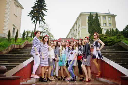 Fabulous bride with her awesome bridesmaids posing next to the stairs in the downtown. Bachelorette party. photo
