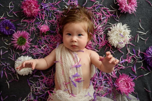 Portrait of little baby girl in white vintage home with flowers photo