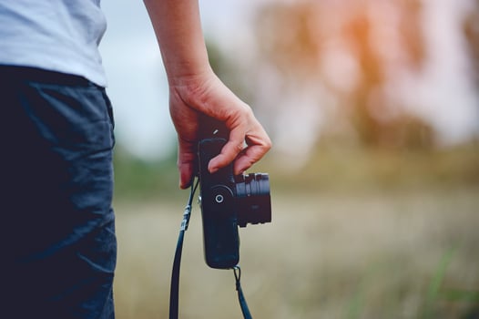 Hand and camera of the photographer Holding and carrying the camera to take pictures photo