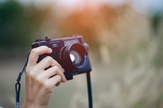 Hand and camera of the photographer Holding and carrying the camera to take pictures photo