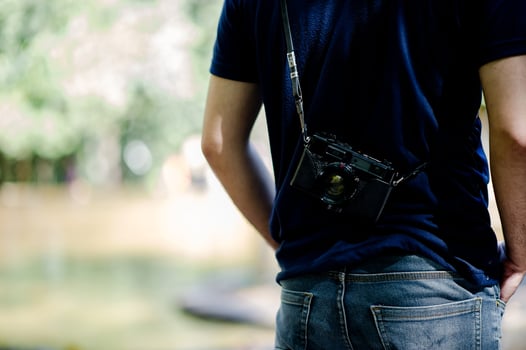 Hand and camera of the photographer Travel in the mountains and nature Concept photographer photo