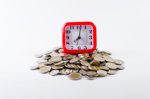 Money, baht coins on a white background and a red clock photo