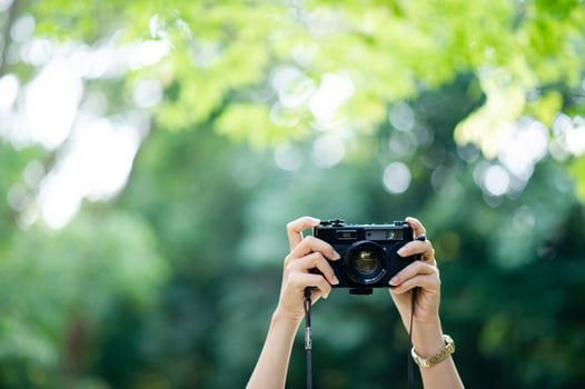 Photographer and camera lover Black camera and natural green background photo