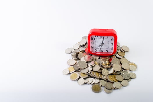 Money, baht coins on a white background and a red clock photo