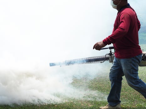 Young man worker are working fogging to eliminate mosquitoes photo