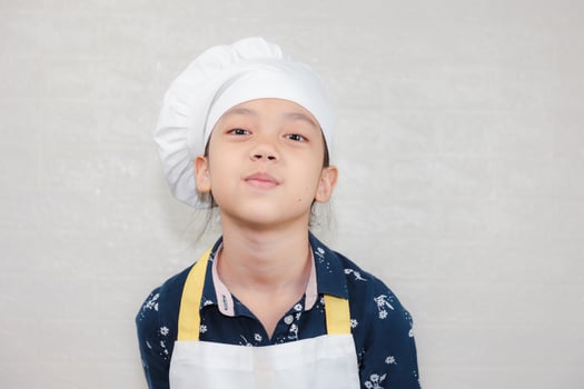 Dream careers concept, Portrait of Happy Kid chef looking at camera with blurred background photo