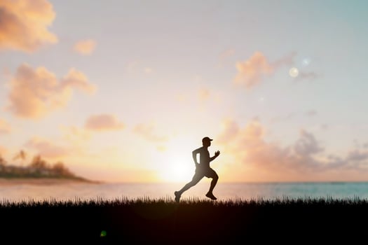 Running man silhouette in sunset time.  silhouette for a runner training in the evening. Sunsets photo