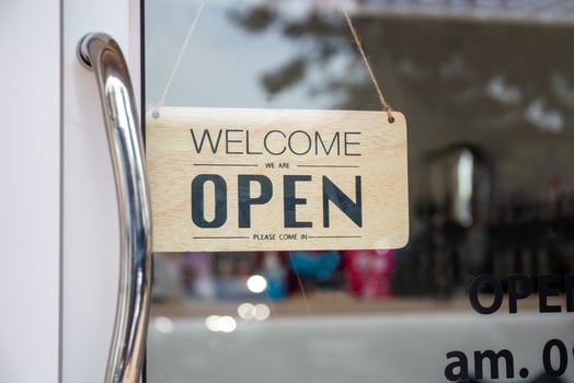 Open sign wooden broad through the glass of window at coffee shop photo